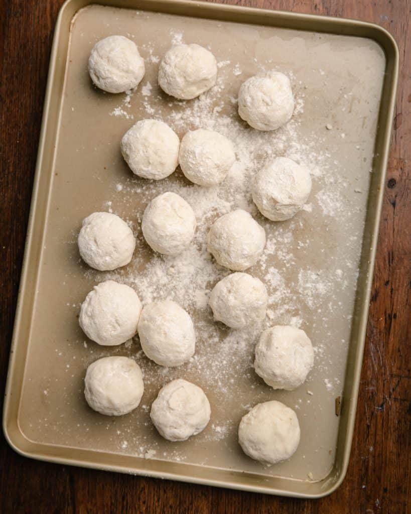 A tray of mashed potato balls dusted in flour