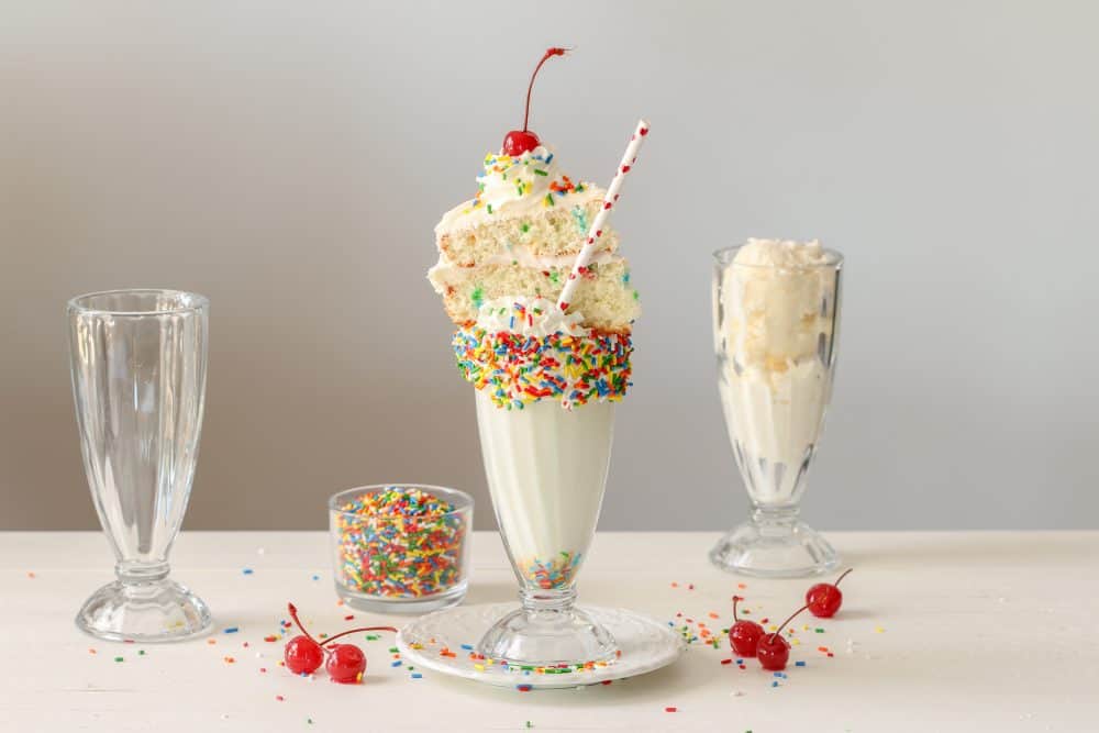 A happy grandmother with glasses and her grandson spend 7 years together in  a cafe. they eat sweet cakes and milkshakes. Stock Photo | Adobe Stock