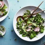 Sugar Snap Pea salad in a white bowl on a blue background