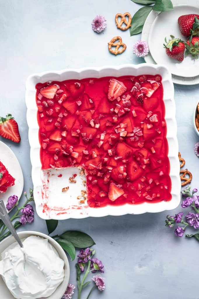 A pan of Jello dessert with chopped strawberries