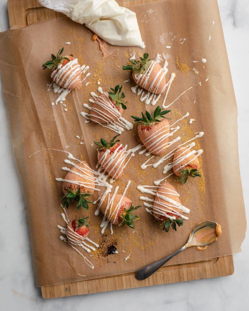 strawberries dipped in white chocolate colored with orange food coloring