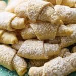 A stack of kifle cookies on a plate