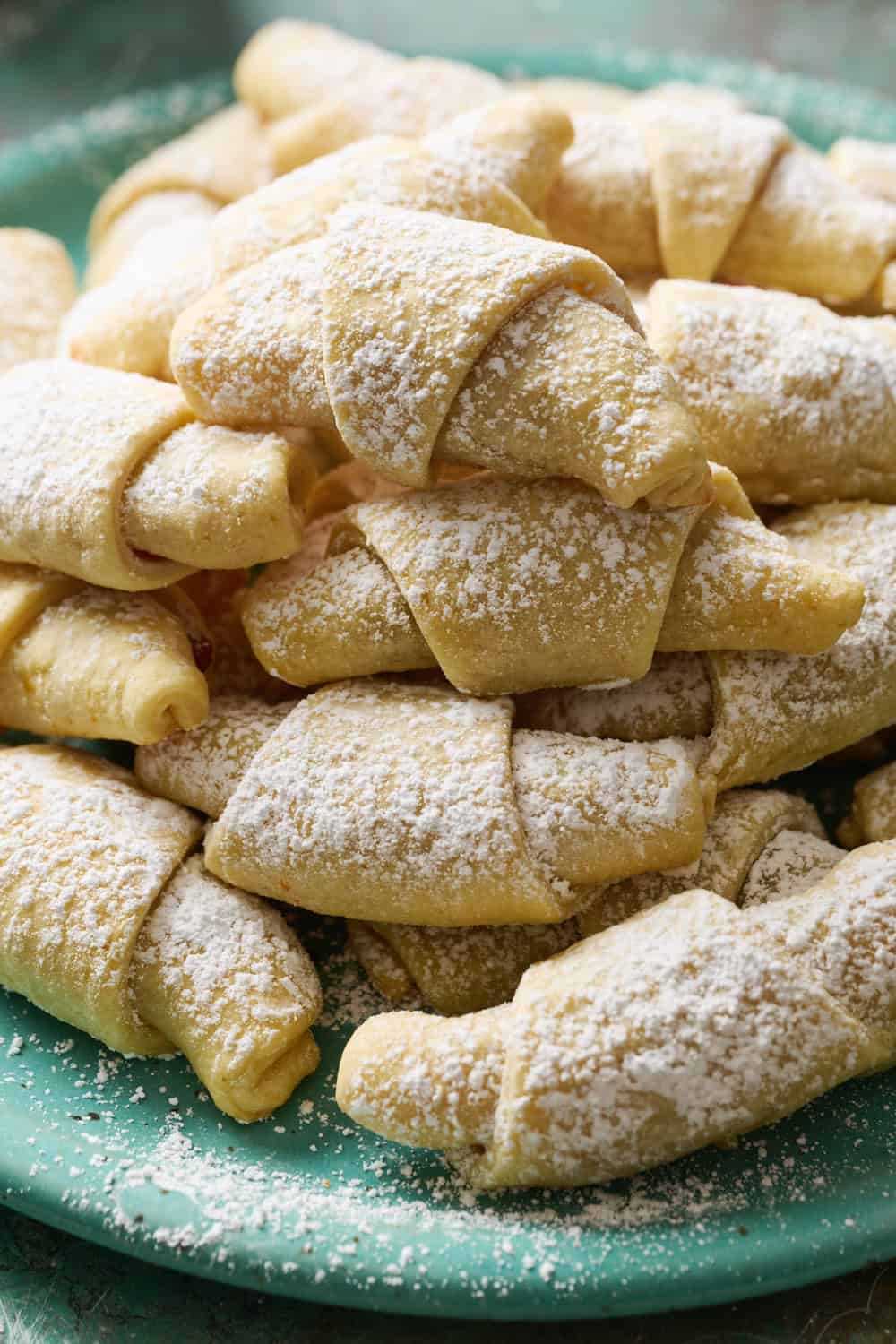 A stack of kifle cookies on a plate