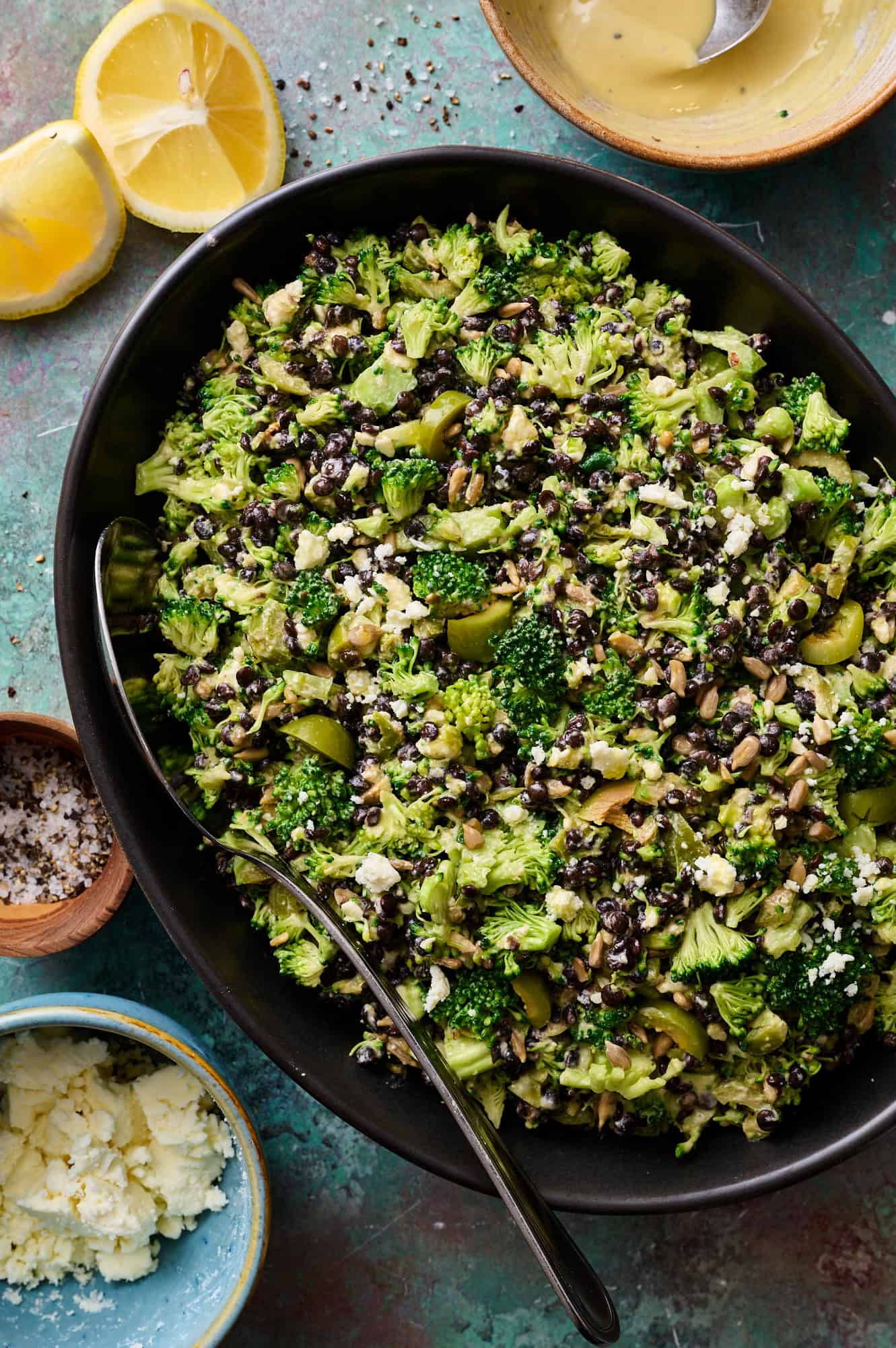 lentil broccoli salad in a large serving bowl with dressing on the side