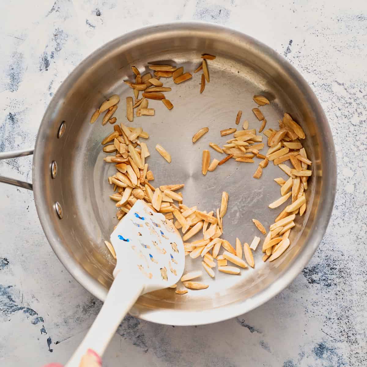 toasting almonds in butter in a saucepan