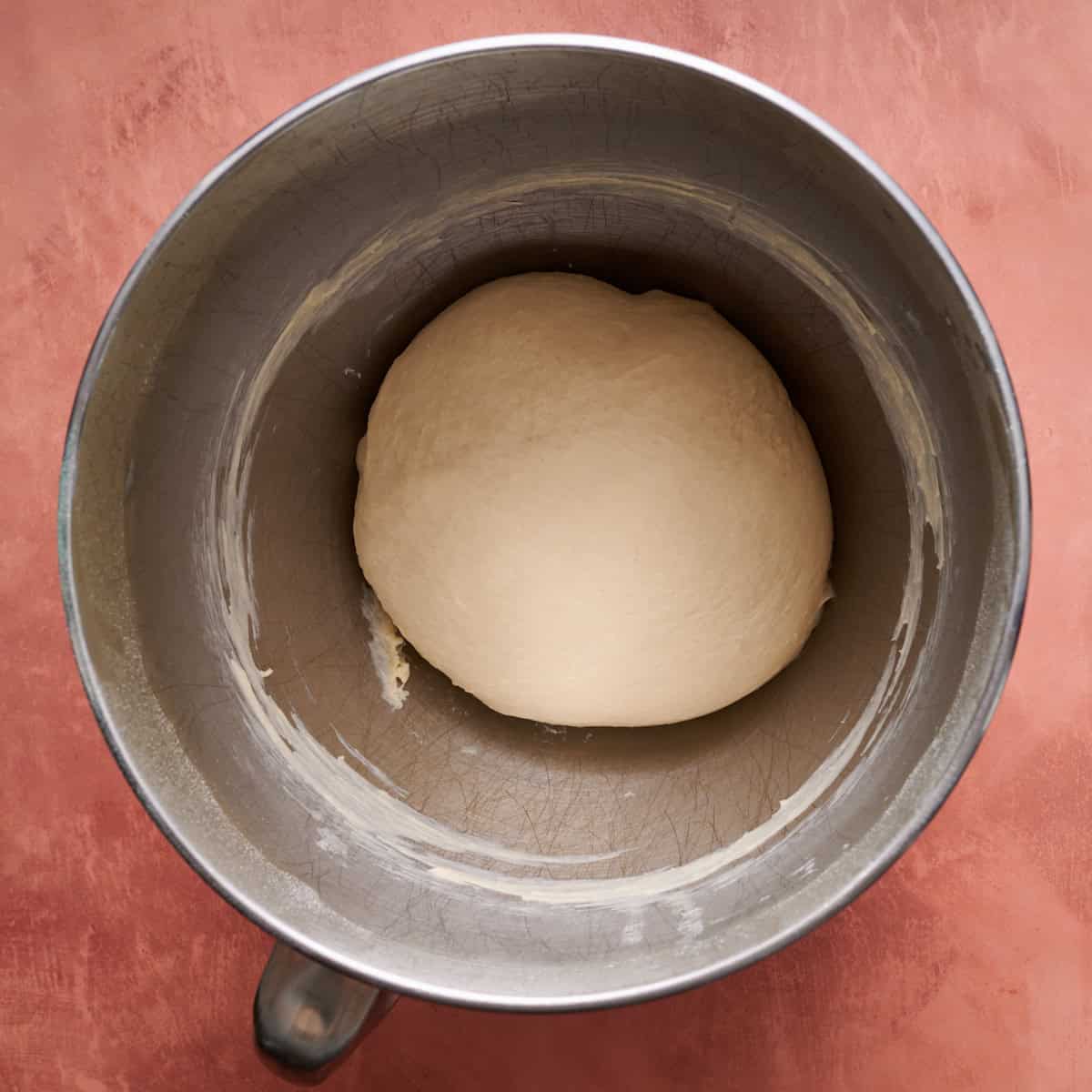 the dough in a mixing bowl after being mixed before it's rise