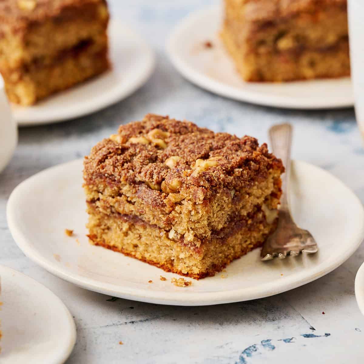 a slice of coffee cake on a plate with a fork