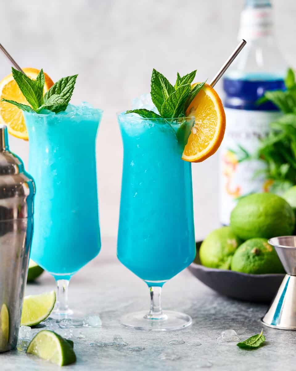 finished garnished Blue Ocean Mocktail drink with orange and mint
