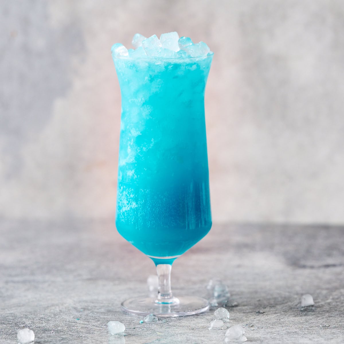 adding ice to the drink in the glass