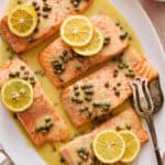 salmon piccata with capers and garnished with fresh lemon