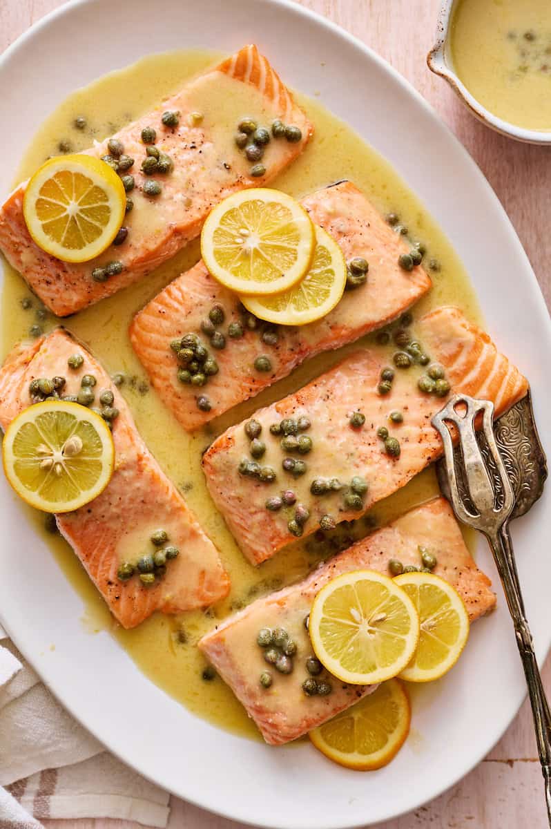 salmon piccata with capers and garnished with fresh lemon