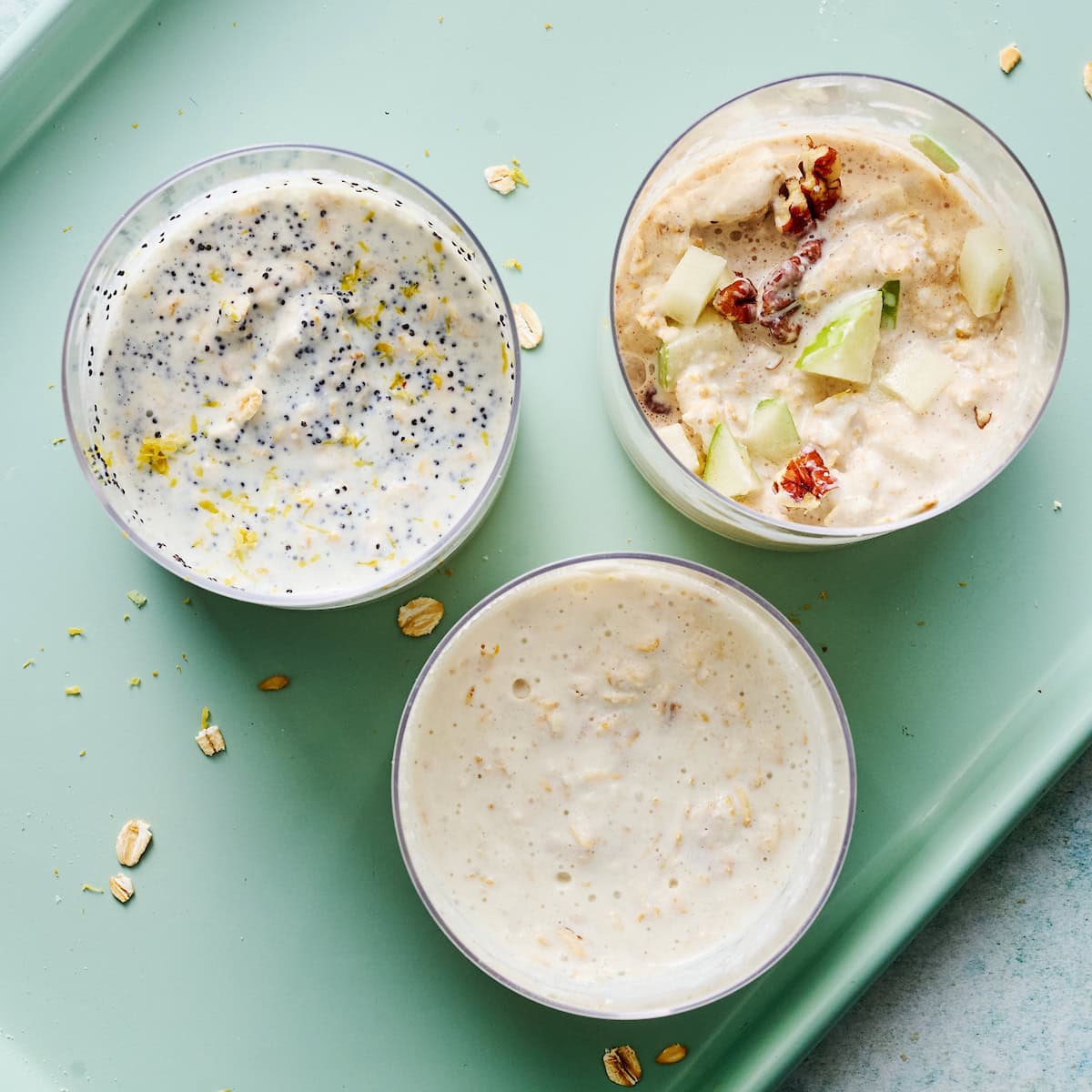 three varieties of greek yogurt overnight oats mixed and ready to refrigerate