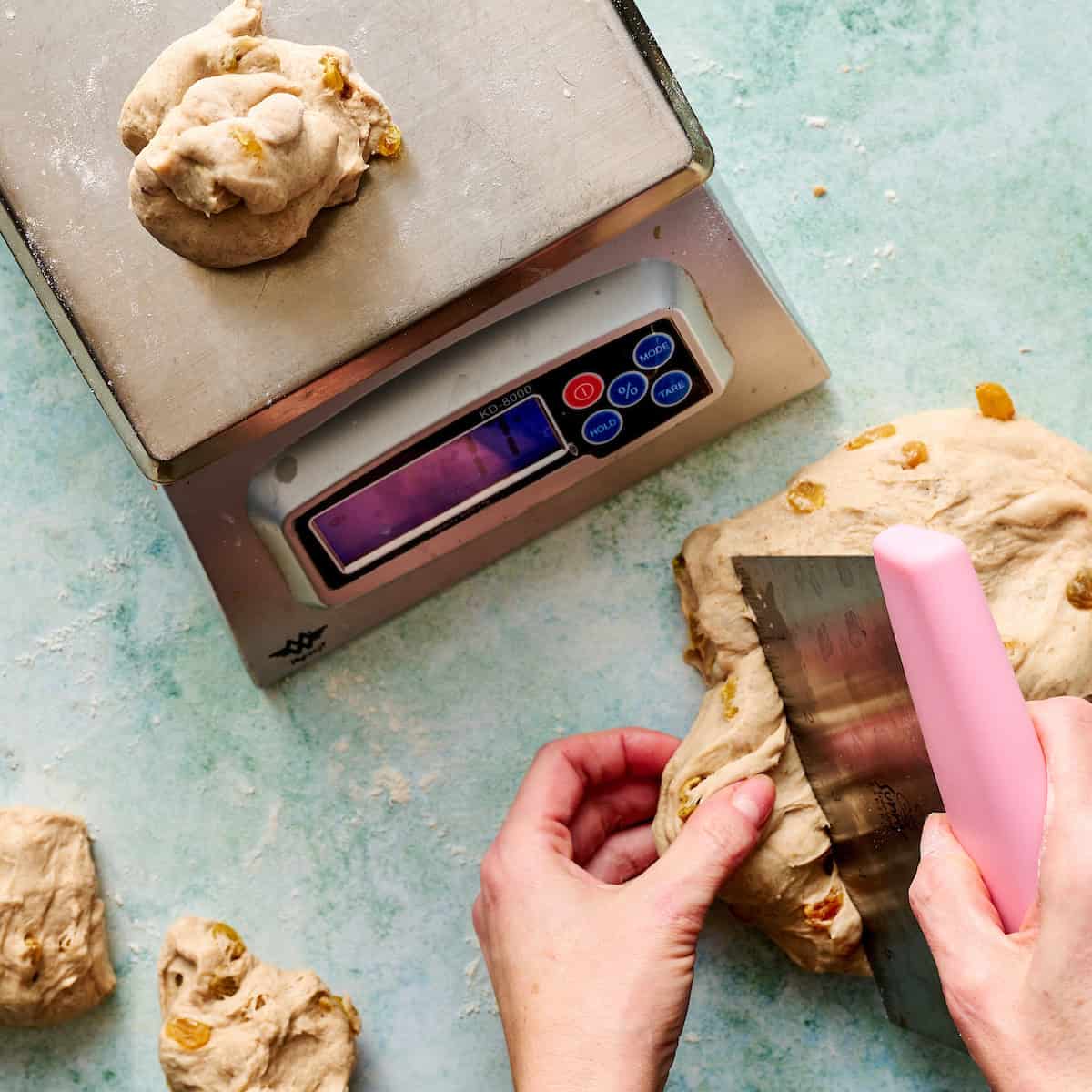 cutting down dough into individual rolls