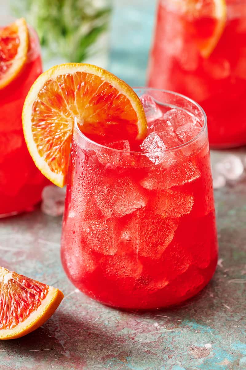 Glass of blood orange mocktail with ice and fresh sliced citrus
