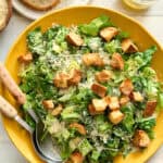 caesar salad with two kinds of parmesan cheese, lemony dressing, croutons and romaine lettuce served with sourdough bread