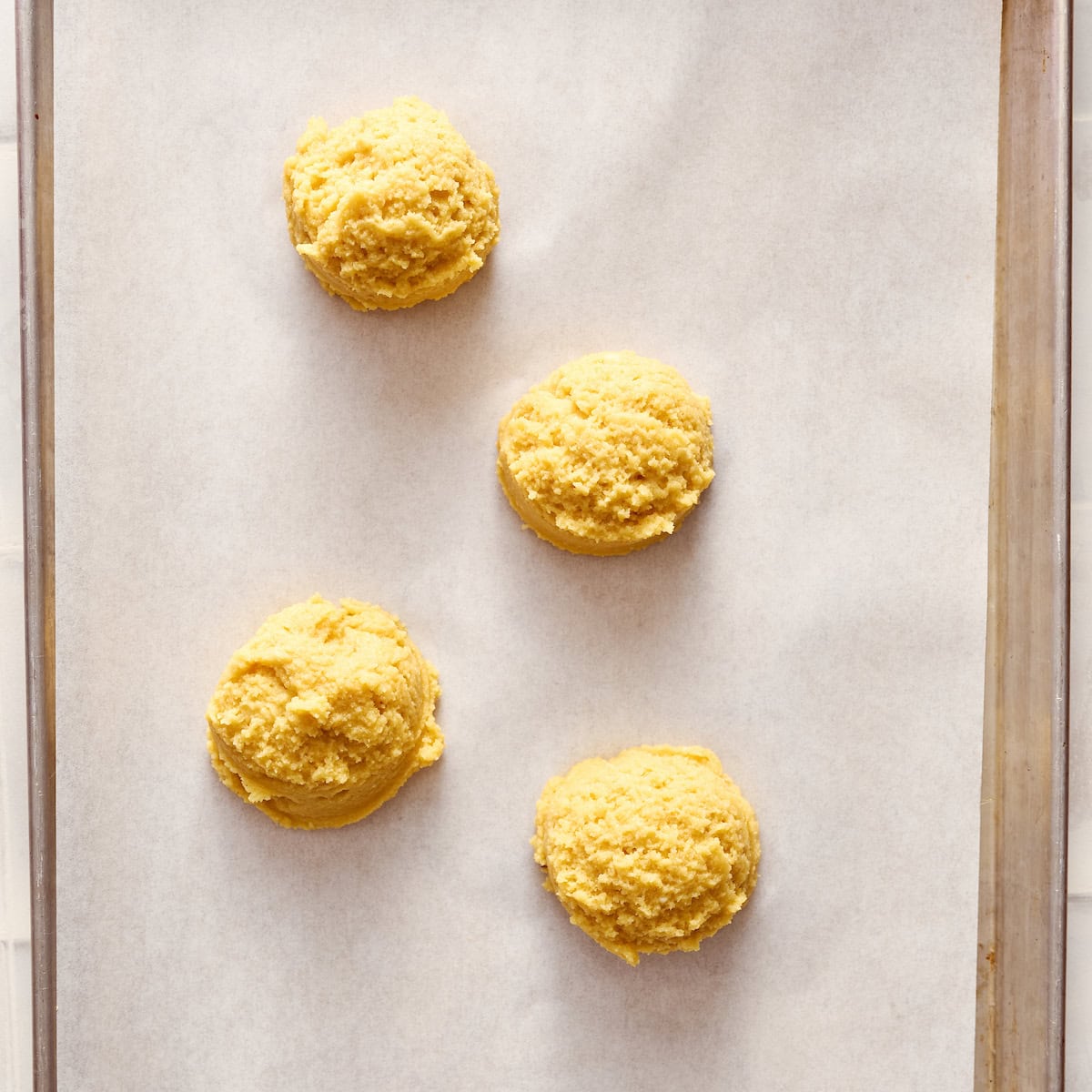 shortcakes on a parchment paper on a baking sheet before baking
