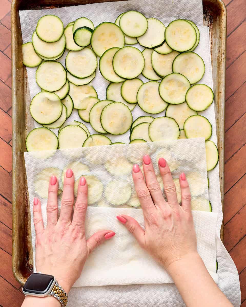 patting zucchini with paper towels