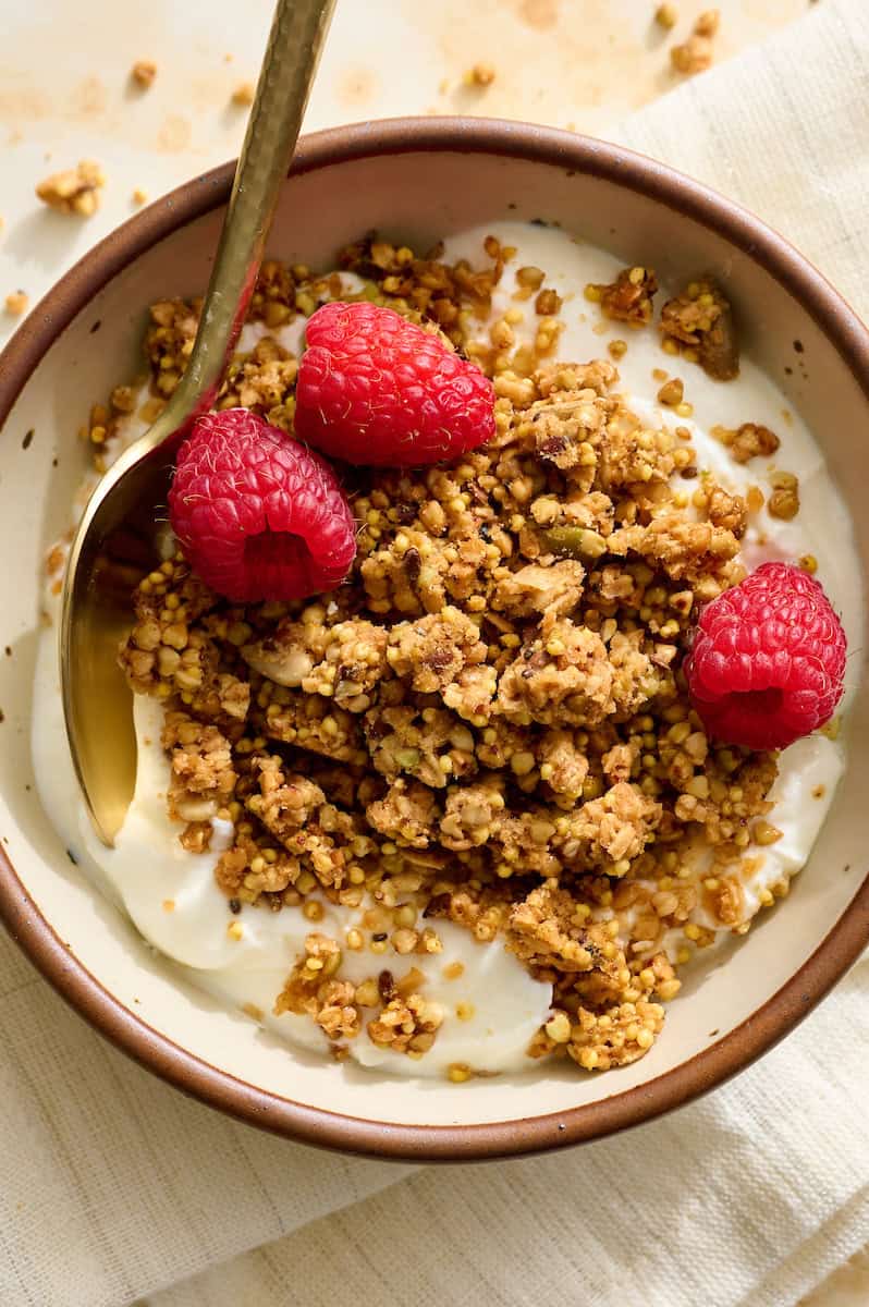 buckwheat granola on top of yogurt with berries