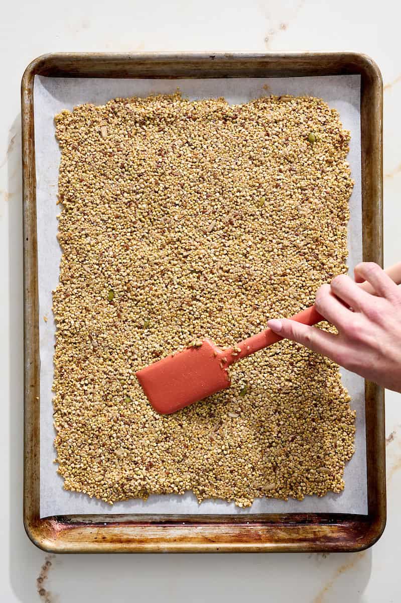 spreading granola into a thin layer