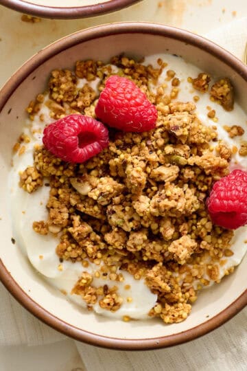 buckwheat granola on top of yogurt with berries