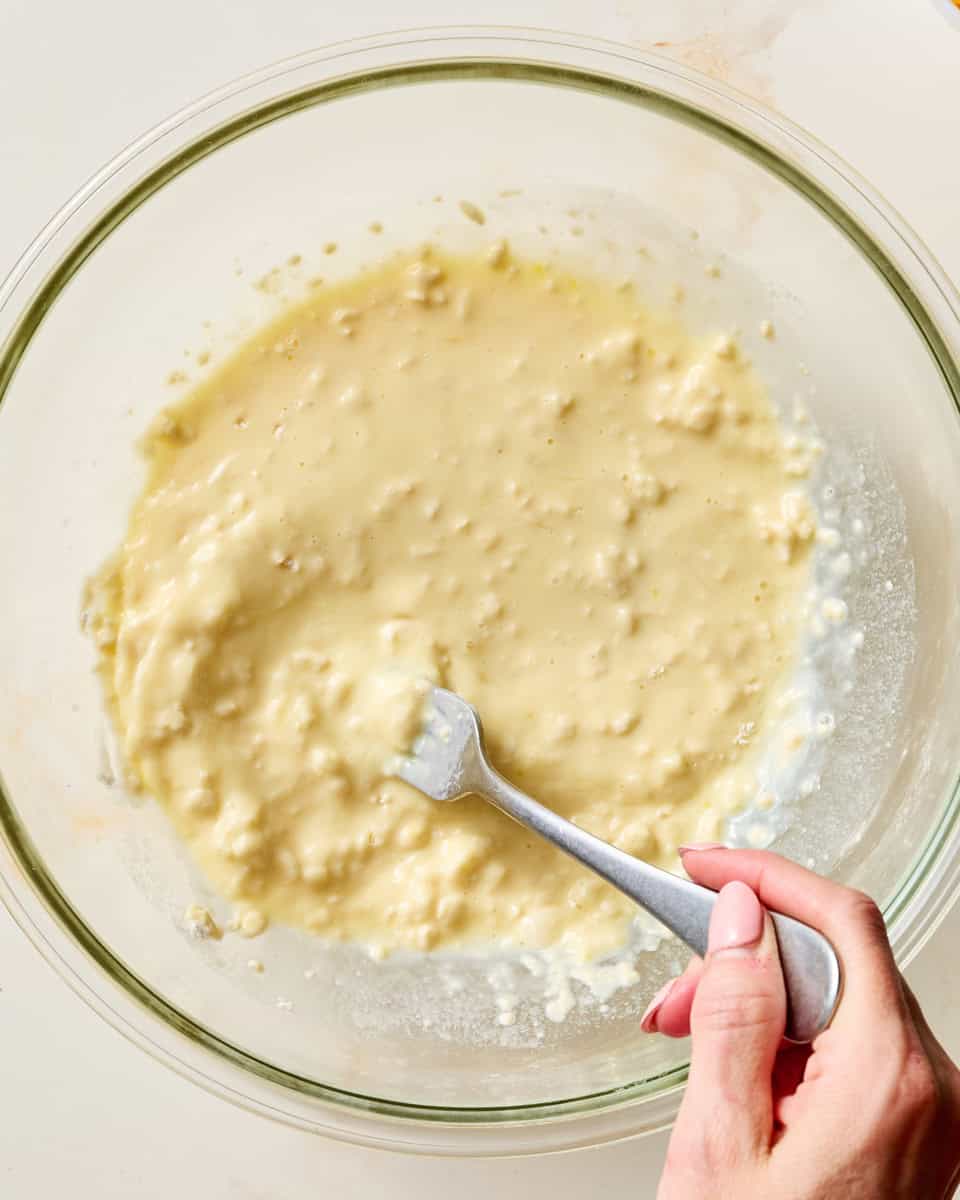 adding milk and eggs to the homemade biscuit mixture
