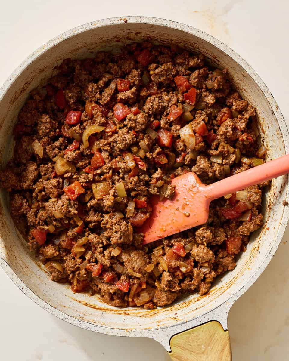 adding the taco seasoning and rotel to the meat mixture