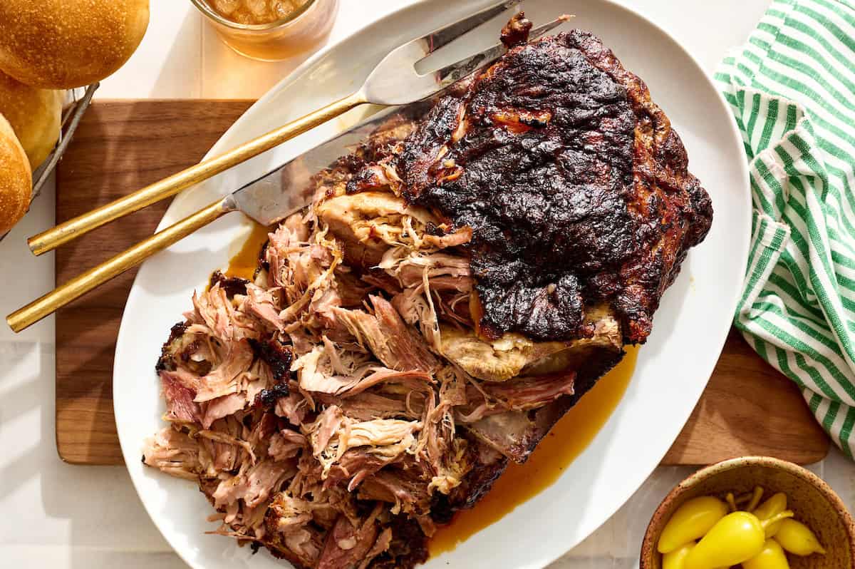 pork roast in the pan after cooking with the probe inserted and showing internal temp of 200F