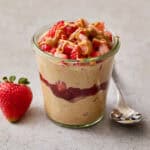 pb&j overnight oats with protein topped with berries and peanut butter