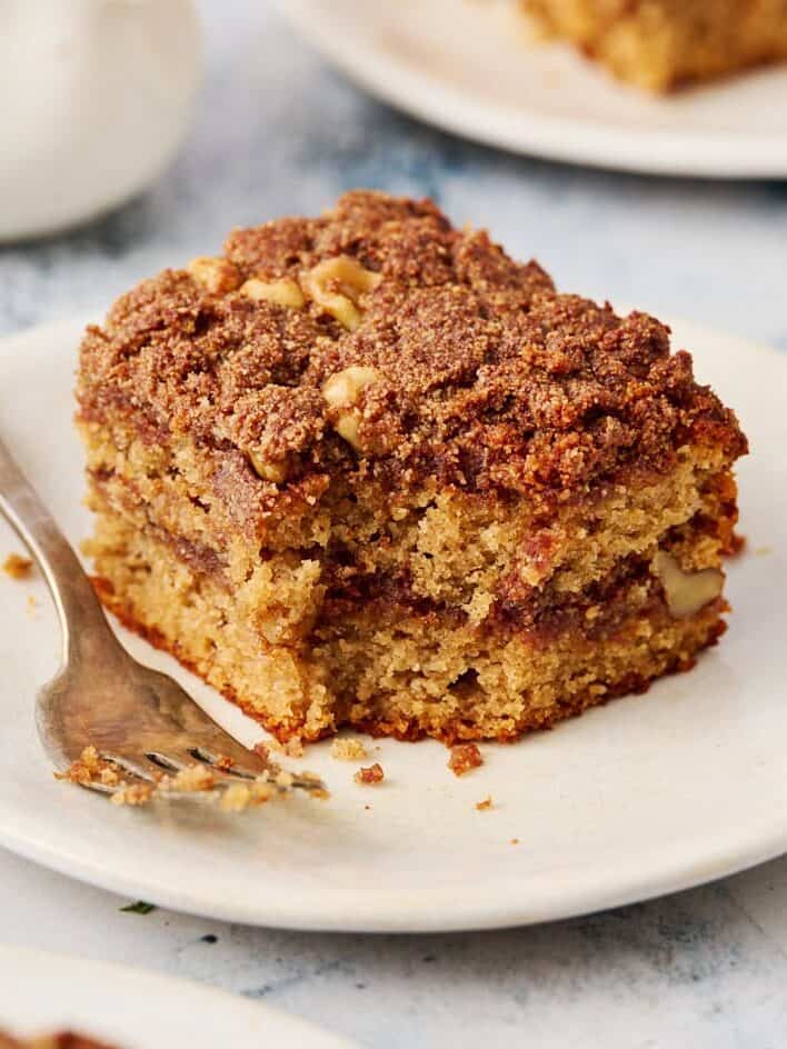 a slice of coffee cake on a plate with a fork