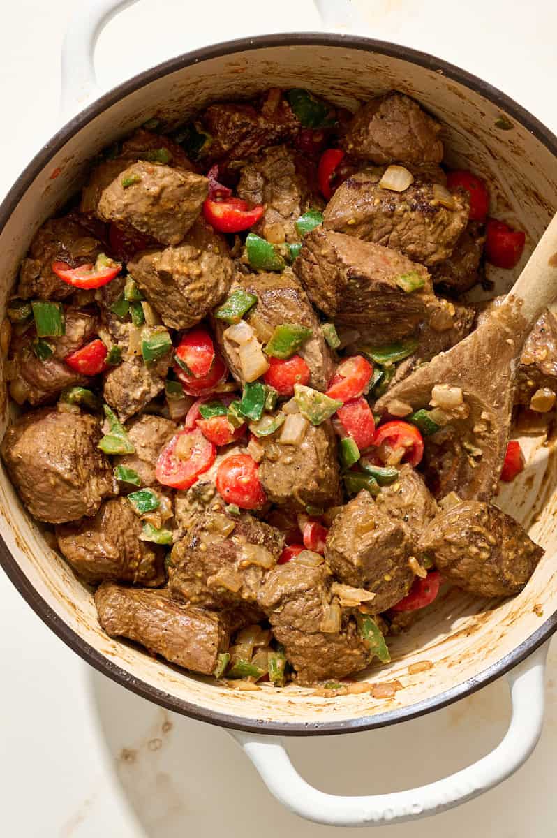 adding flour and beef to the sauteed veggie mixture