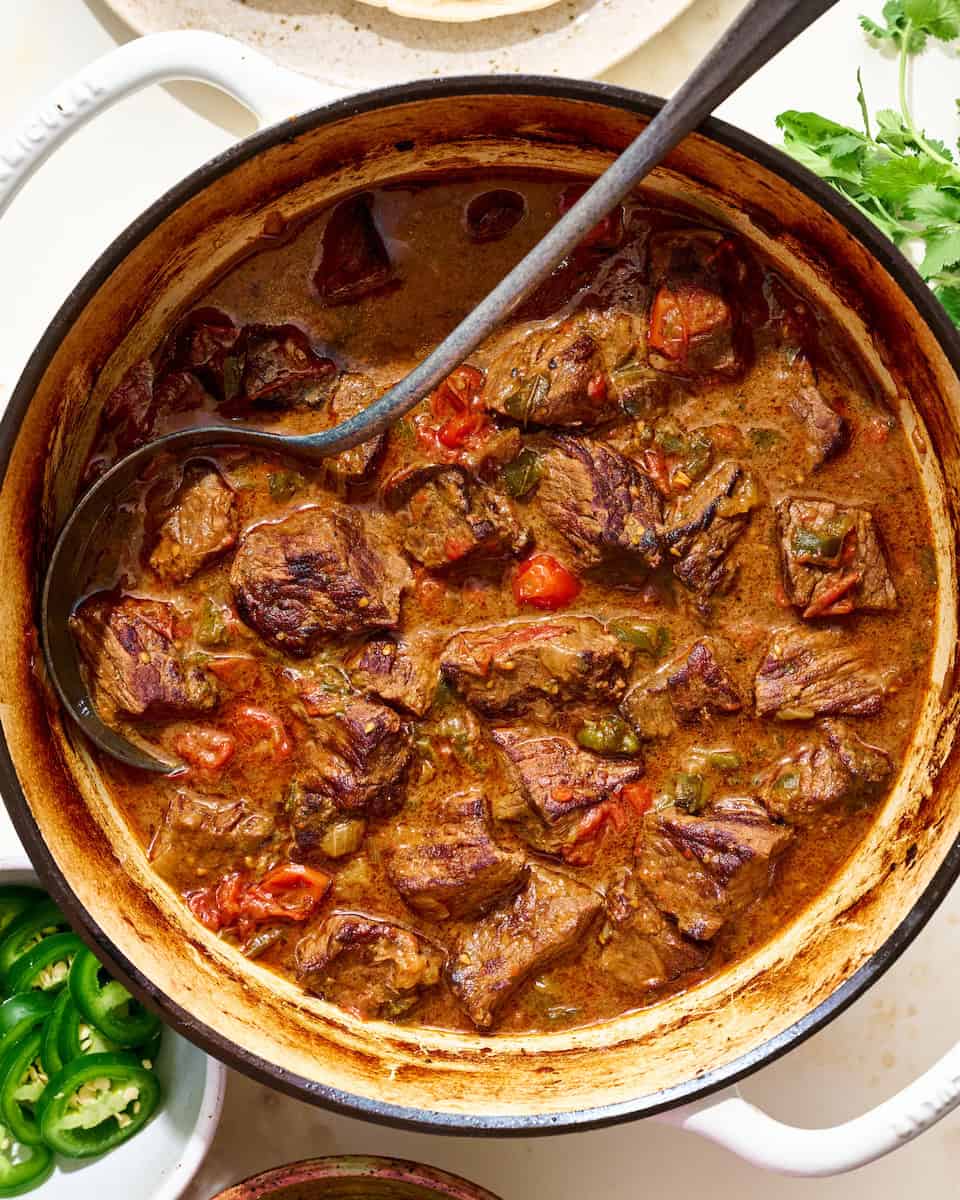 Hearty beef stew with vegetables in a rustic pot, perfect for comfort food.
