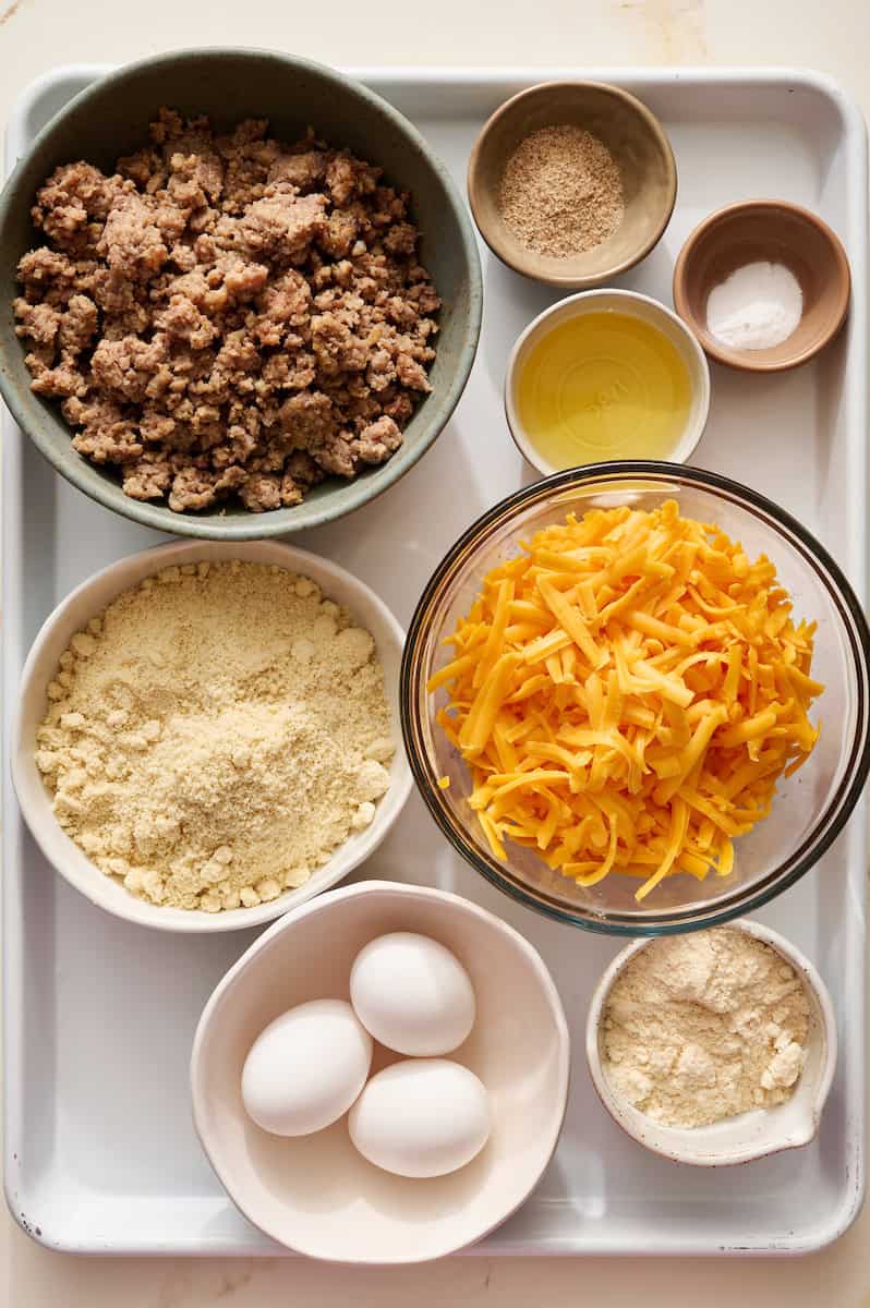 ingredients to make sausage breakfast muffins including cheese, psyllium husk and eggs