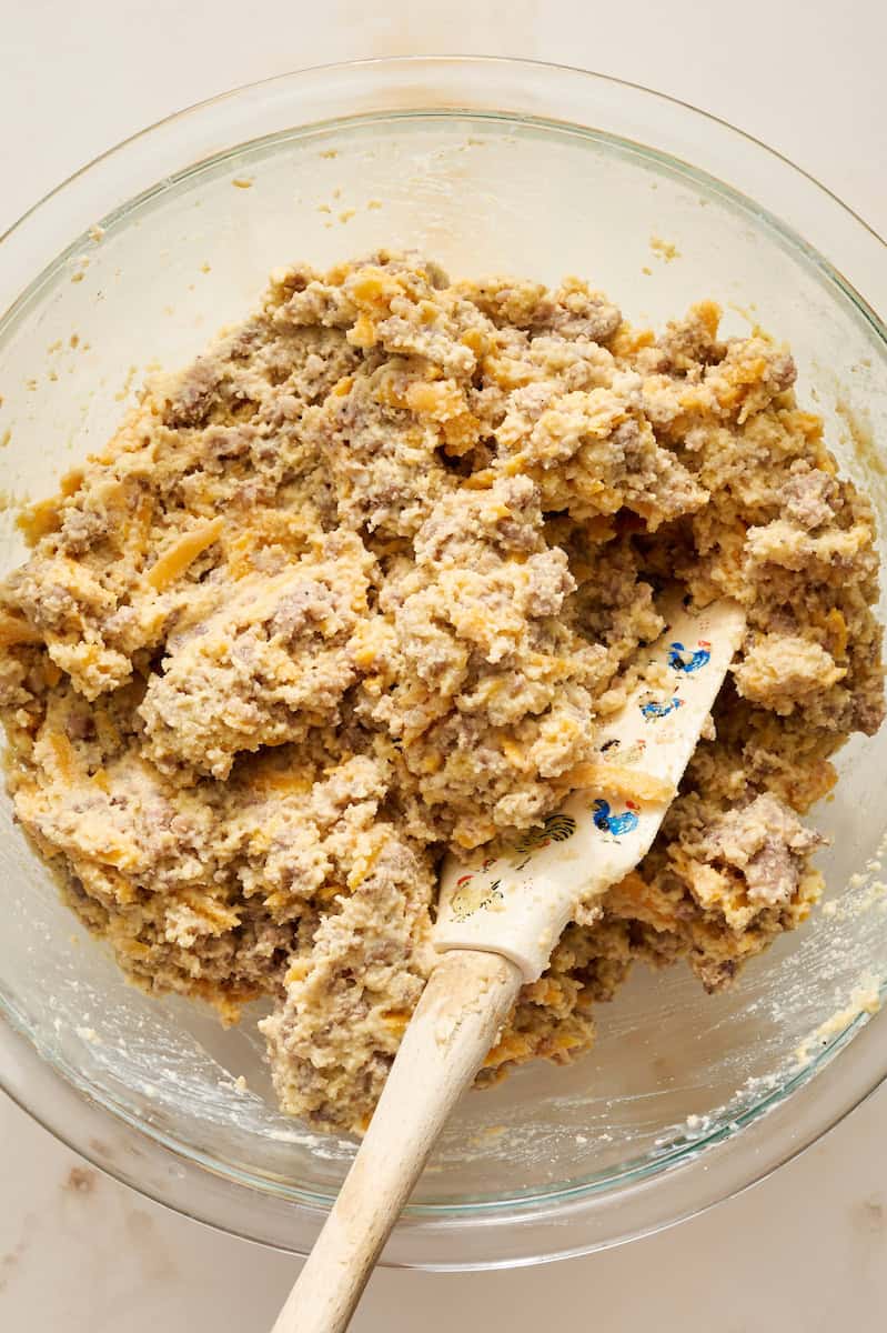 adding sausage and cheese to the batter