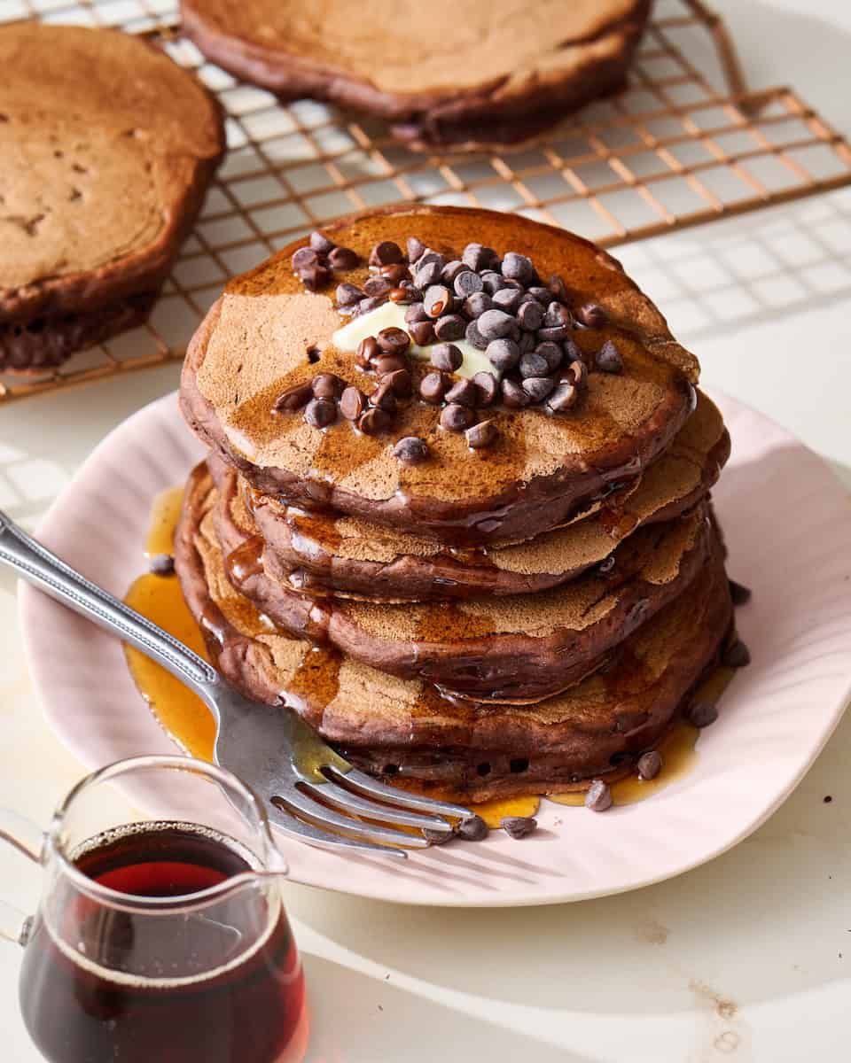 chocolate sourdough pancake stack with maple syrup and chocolate chips