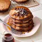 chocolate sourdough pancake stack with maple syrup and chocolate chips