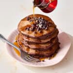 chocolate sourdough pancake stack with maple syrup and chocolate chips