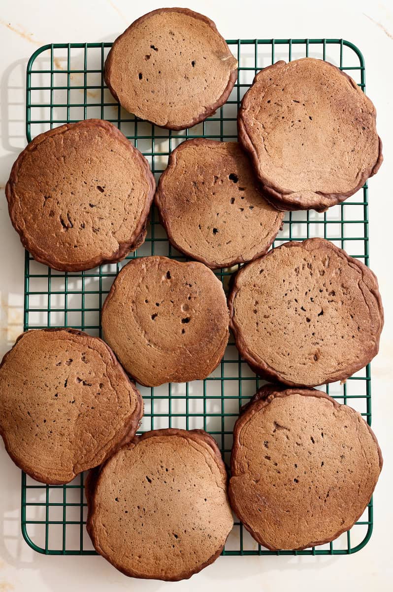 chocolate sourdough pancakes cooling on a rack