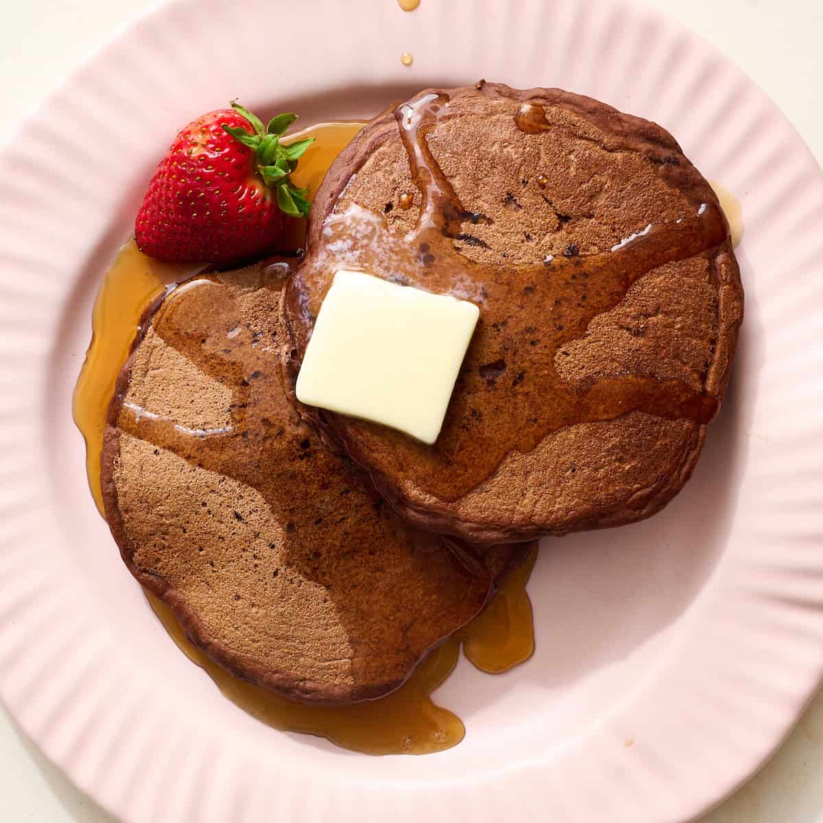 chocolate sourdough pancakes topped with syrup and butter