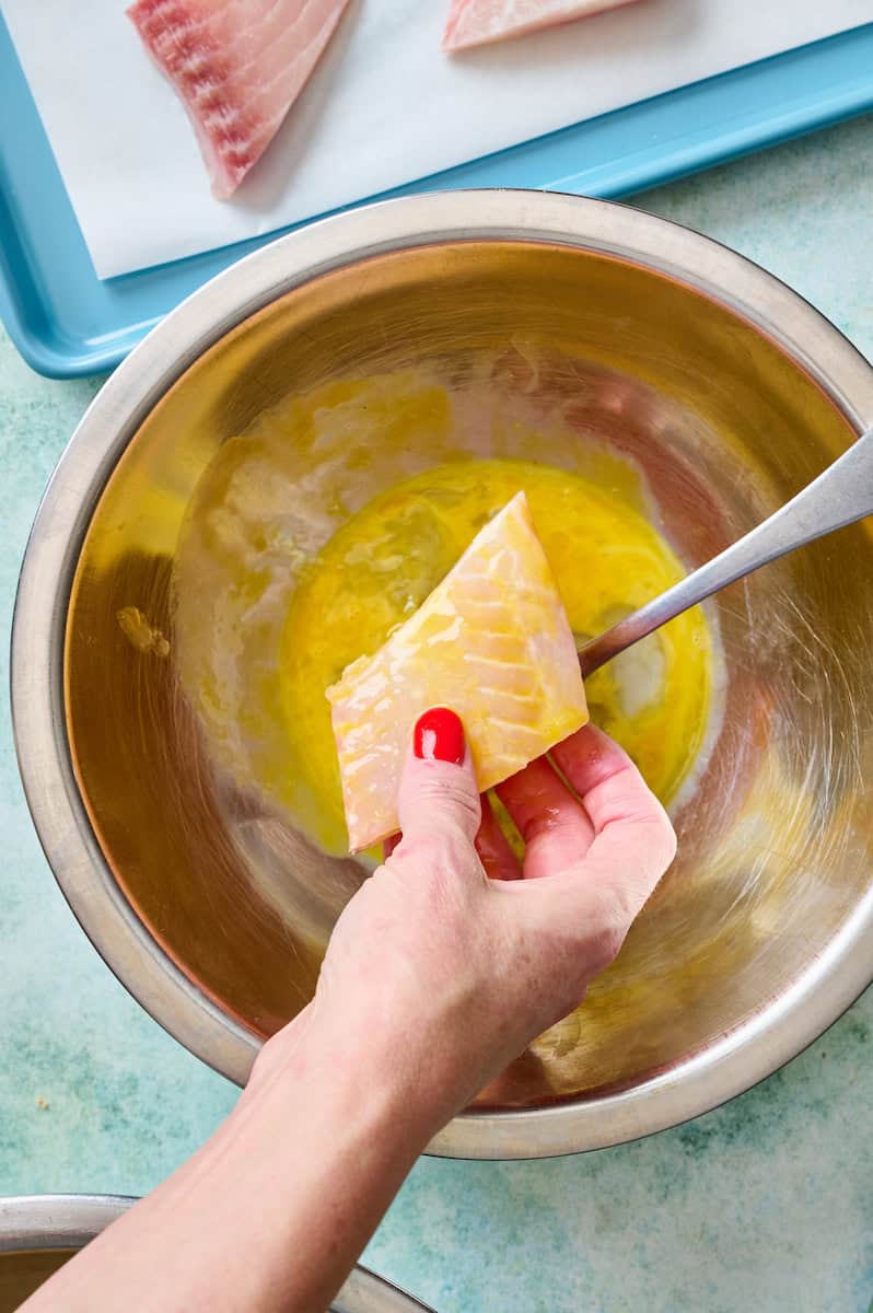 dipping fish in a beaten egg