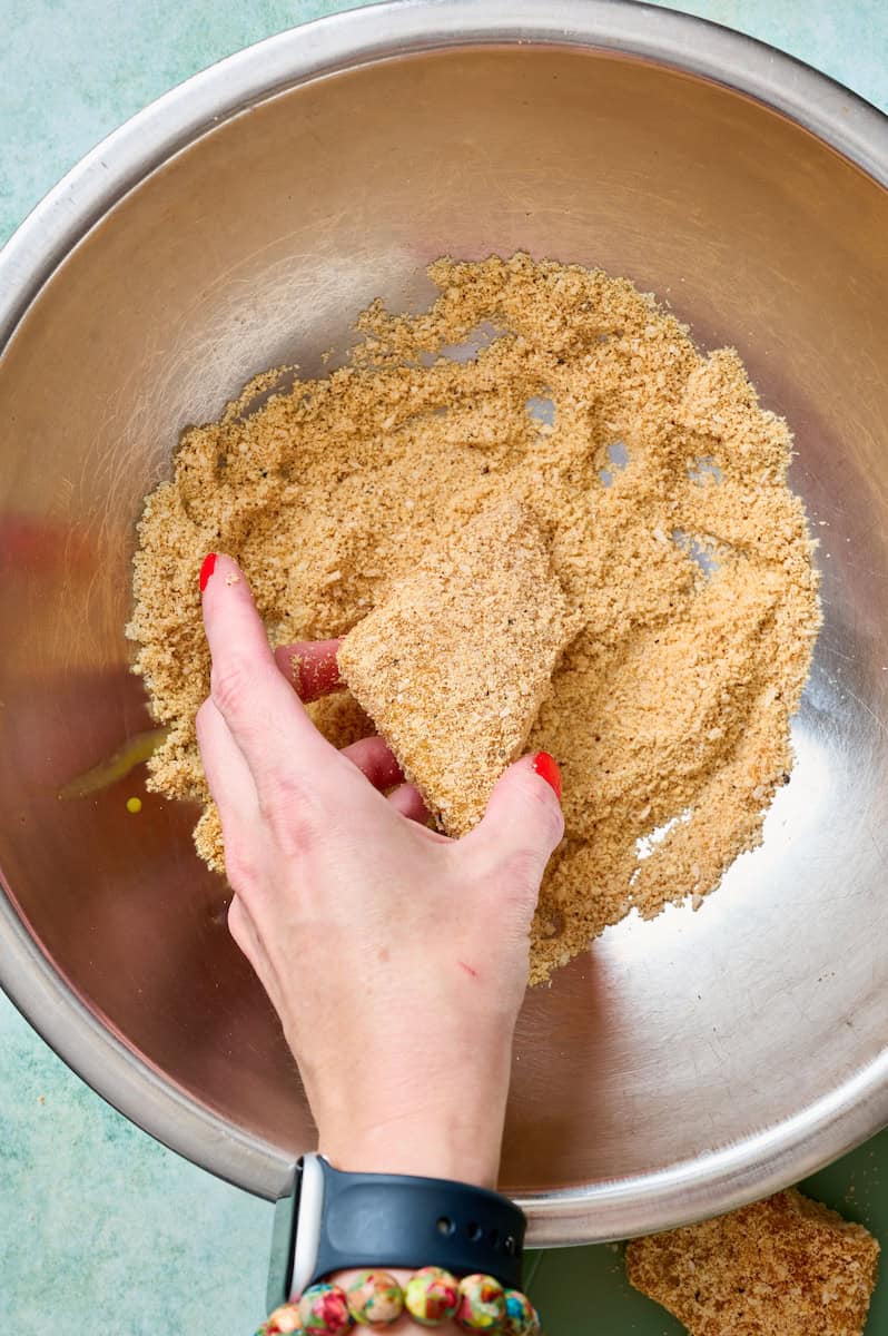 tossing the fish pieces in the breading mix