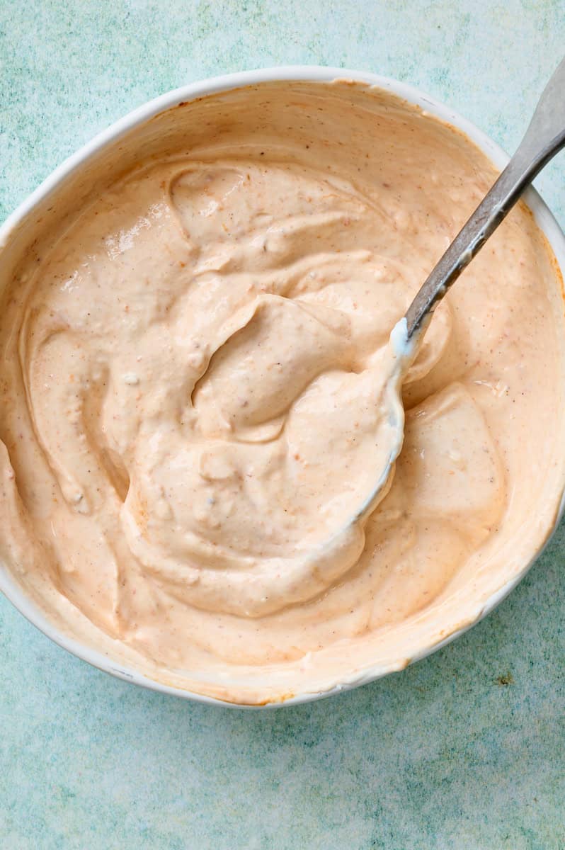 mixing up a greek yogurt hot sauce lime sauce