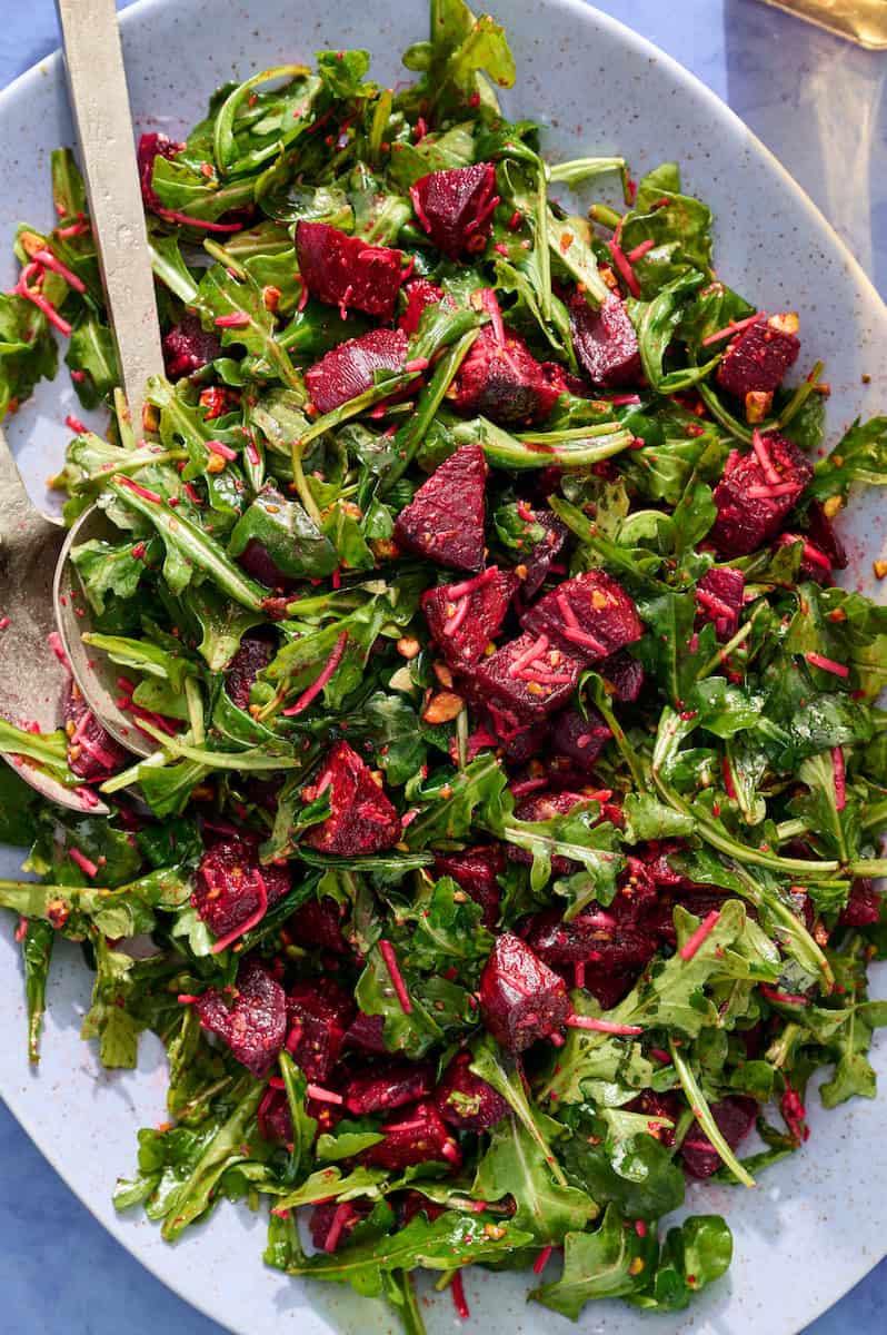 a bed of arugula topped with the beet mixture