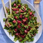 a bed of arugula topped with the beet mixture