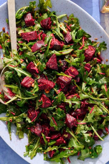 a bed of arugula topped with the beet mixture