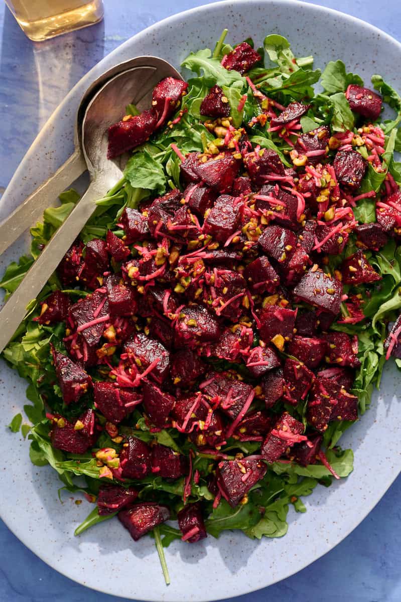 a bed of arugula topped with the beet mixture