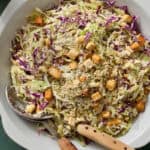 salad in a bowl with tongs topped with croutons ready to serve
