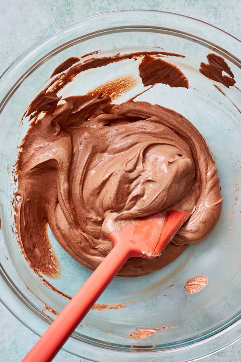 folding together the whipped cream and the chocolate base