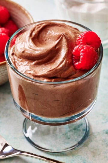 cottage cheese chocolate mousse in a glass with raspberries on the side