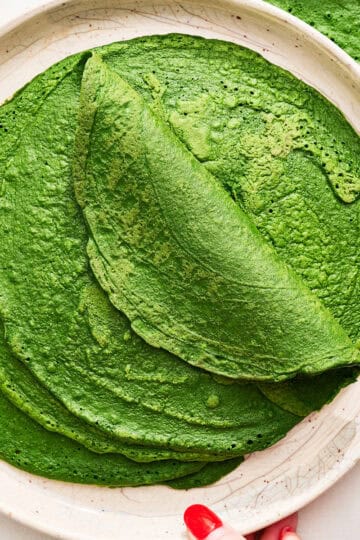 spinach tortillas folded on a plate